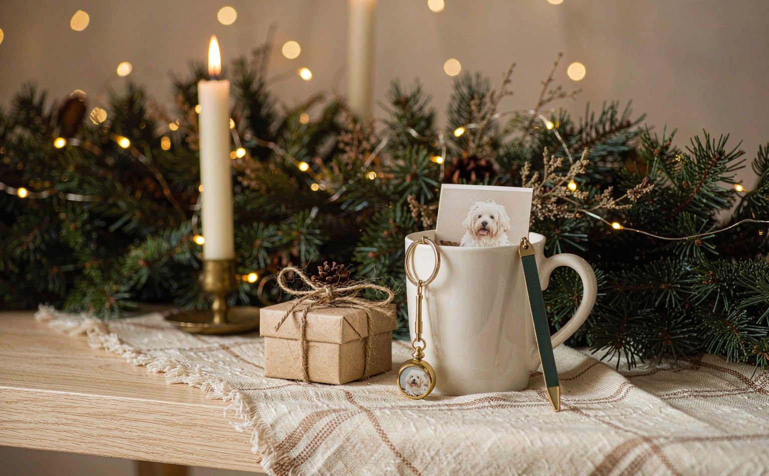 A custom pet photo mug, keychain and small gift box in a holiday setting &mdash; Christmas pet memorial gifts