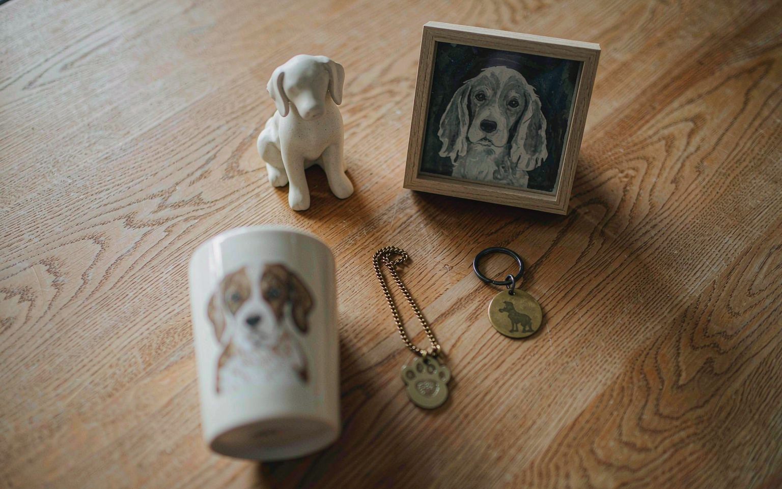 Handmade pet memorial keepsakes arranged on an oak table — pet loss gift ideas at every budget